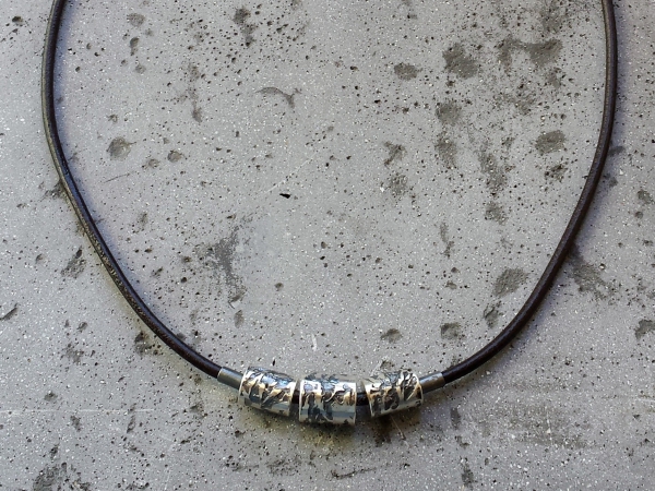 Atelier Solstice – Collier de perles forgées en argent oxydé et cordon cuir.